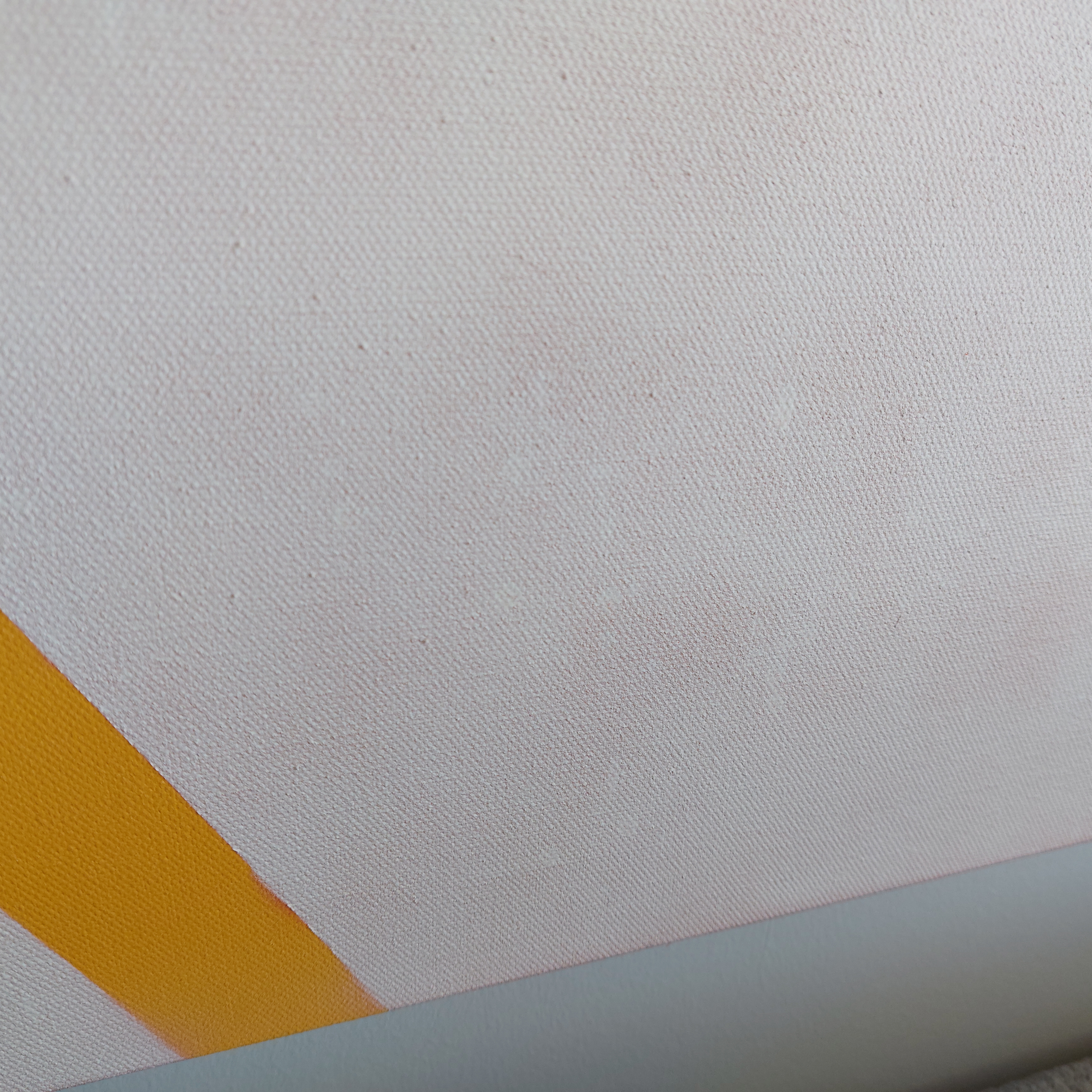 A picture of the aftermath of splotchy spray painting on a canvas.